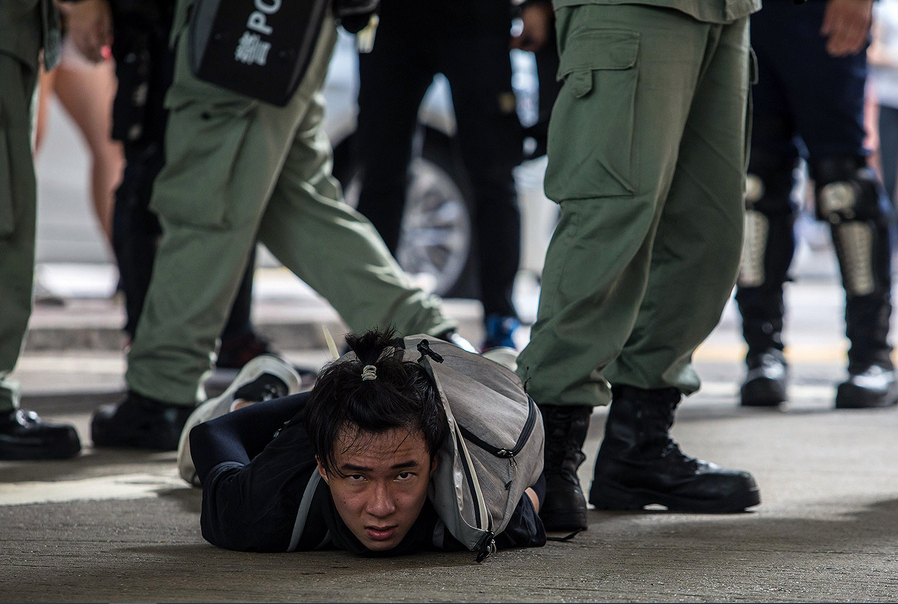 On July 1, the 23rd anniversary of Hong Kong’s handover from Britain to China, Hong Kong riot police make their first arrests under Beijing’s new national security law. DALE DE LA REY/AFP via Getty Images
