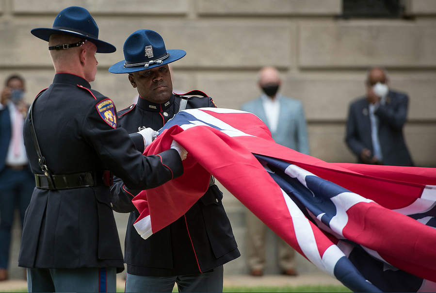 Members of the Mississippi Highway Safety Patrol Honor Guard retire the state flag outside the Capitol building in Jackson, Mississippi, on July 1. The flag, the last in the United States to feature a Confederate emblem, was permanently retired. RORY DOY