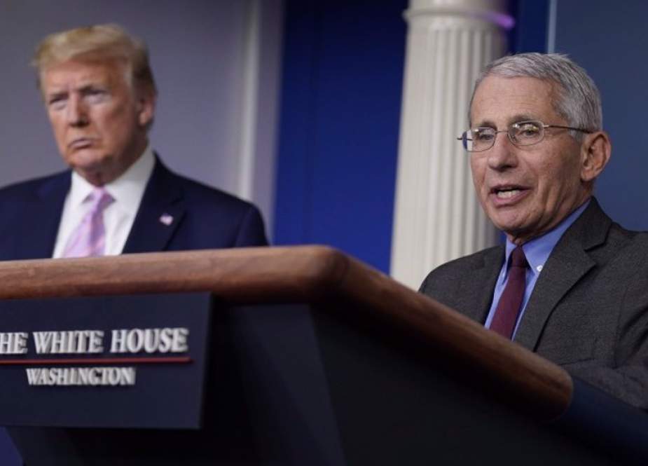 US President Donald Trump listens as Dr. Anthony Fauci speaks during a coronavirus briefing at the White House.jpg
