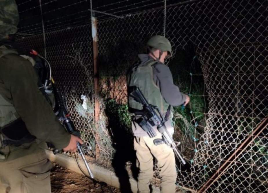 Israeli occupation forces examining border fence with Lebanese territories.jpg