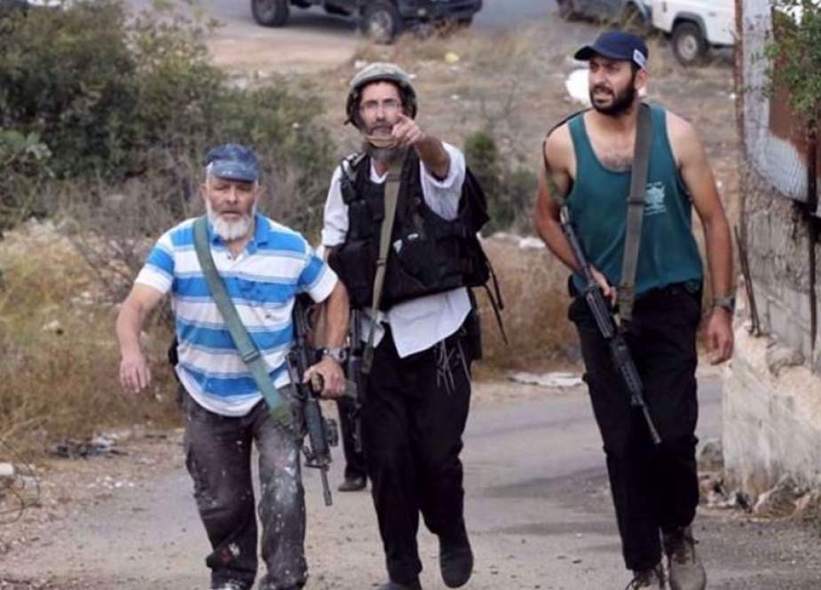 Armed Israeli settlers in an area of the occupied West Bank.jpg