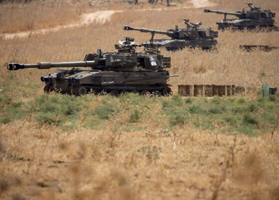 Israeli mobile artillery units sit in place in northern Israel near the border with Lebanon.jpg