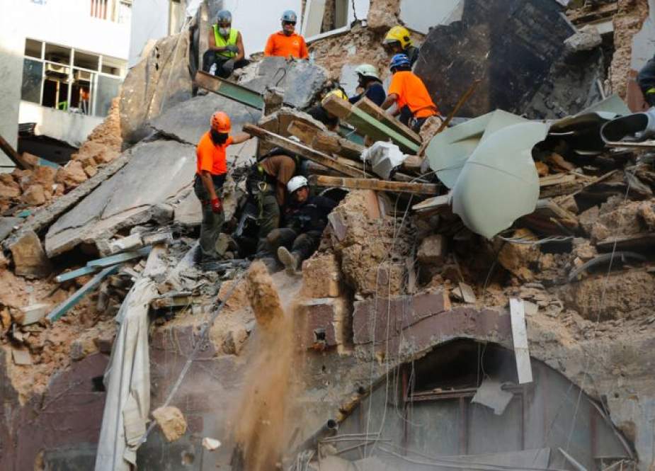 Chilean and Lebanese rescuers at the rubble of a building destroyed in Beirut Port blast.jpg