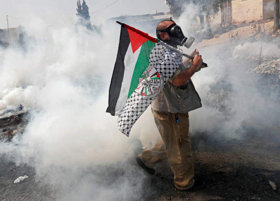 Israeli security forces fire tear gas as Palestinians protest a peace deal with Bahrain in Kafr Qaddum, West Bank.JPG