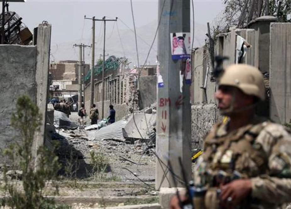 Afghan security personnel stands at the site after a Taliban car bomb detonated at the police station in Kabul.jpg