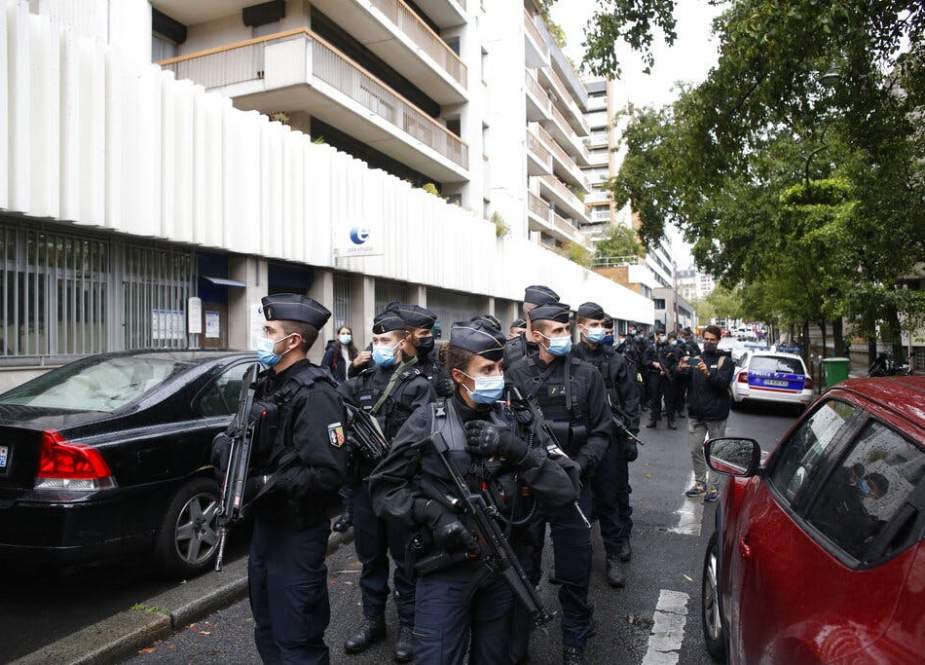 Police arresting a suspect in stabbing attack near Charlie Hebdo