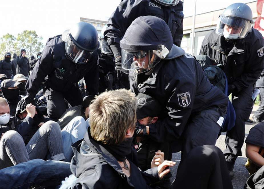 Police detains a counter-protester demonstrating against the far-right party The Third Way in Berlin, Germany.JPG