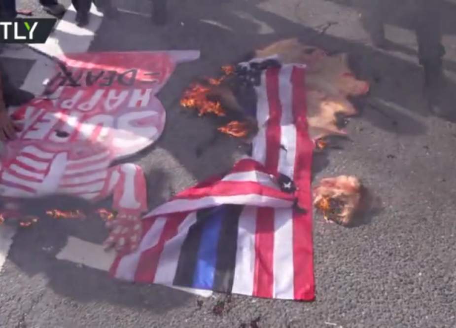 Man burns US flag, anti-Trump protesters face off.