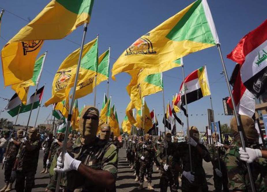 Members of Iraq’s anti-terror Kata’ib Hezbollah group march in Baghdad.jpg