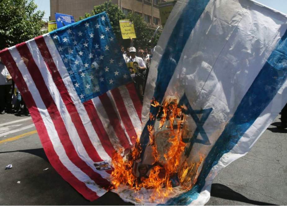 Iranian protesters burns US and Zionis Israel flags.