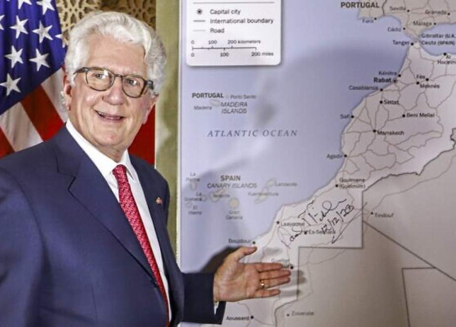 US ambassador to Morocco David Fischer standing before a new map of Morocco.jpg