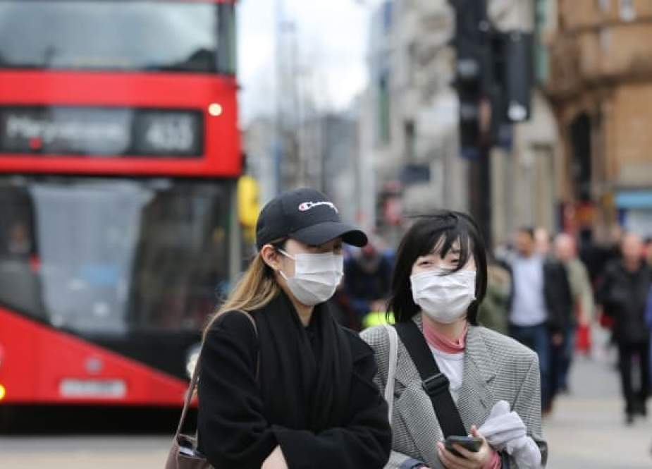 People wear protective masks in central London amid the outbreak of coronavirus.jpeg