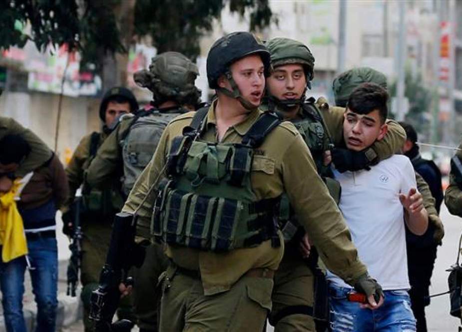 Israeli forces taking a Palestinian minor into custody in the West Bank.jpg
