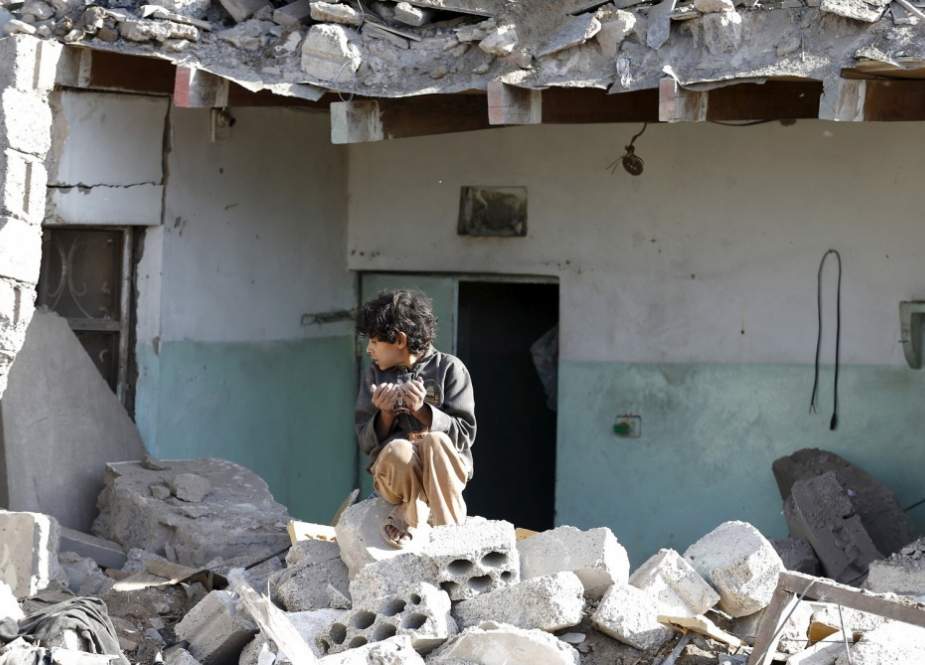 Yemeni child at his destroyed house after a Saudi-led strike.jpg