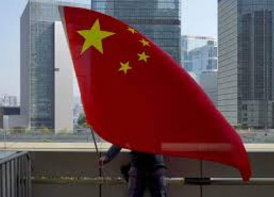 A pro-China supporter holds a Chinese national flags outside High Court in Hong Kong.jpg