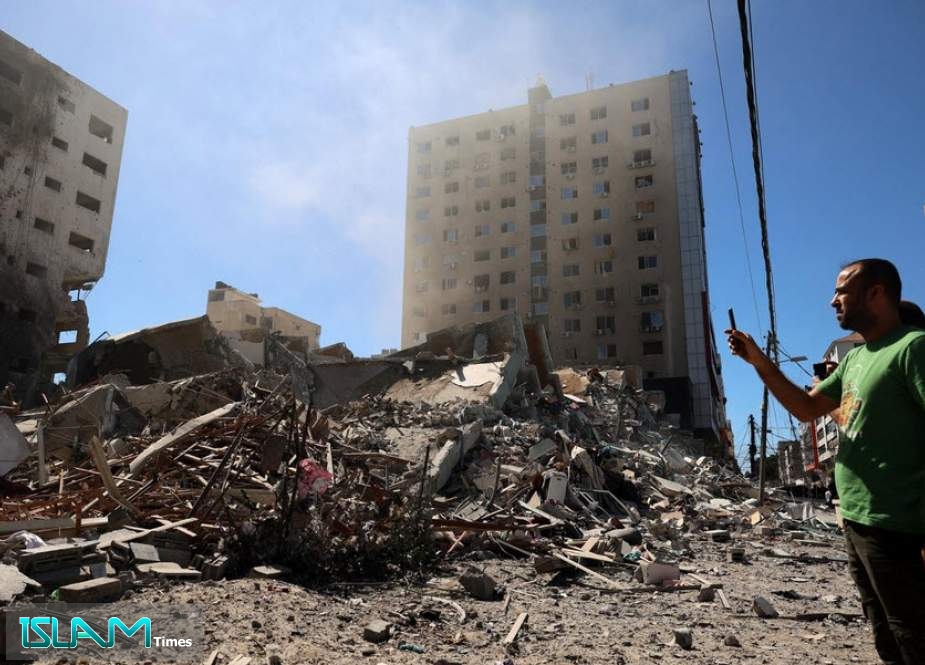 A building hit and destroyed during an Israeli air strike in Gaza City, 15 May (AFP)
