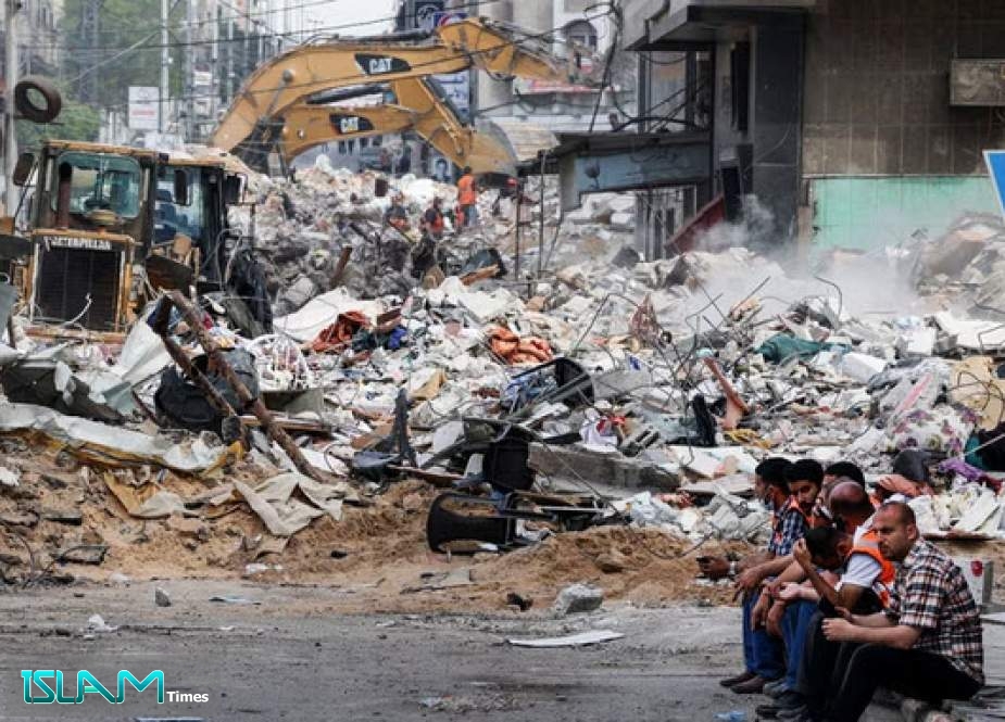 An excavator clears the rubble of a destroyed building in Gaza City on Sunday, following Israeli airstrikes. Mahmud Hams/AFP via Getty Images