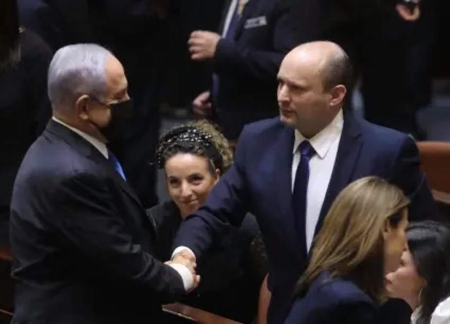 Benjamin Netanyahu offers a brief handshake to Naftali Bennett at the Israeli Knesset.jpg