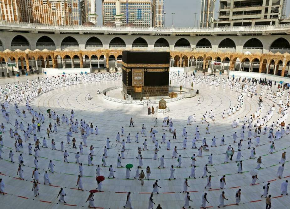 Pilgrims in masks and on distanced paths at Grand Mosque in Mecca.jpg