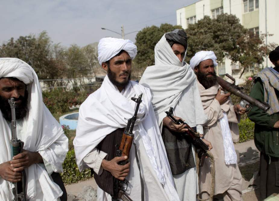 Surrendering Taliban militants stand with their weapons as they are presented to the media.jpg