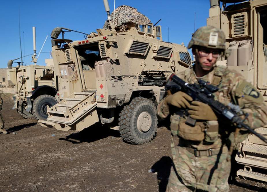 US soldiers stand next a military vehicle in the town of Bartella, Iraq.JPG