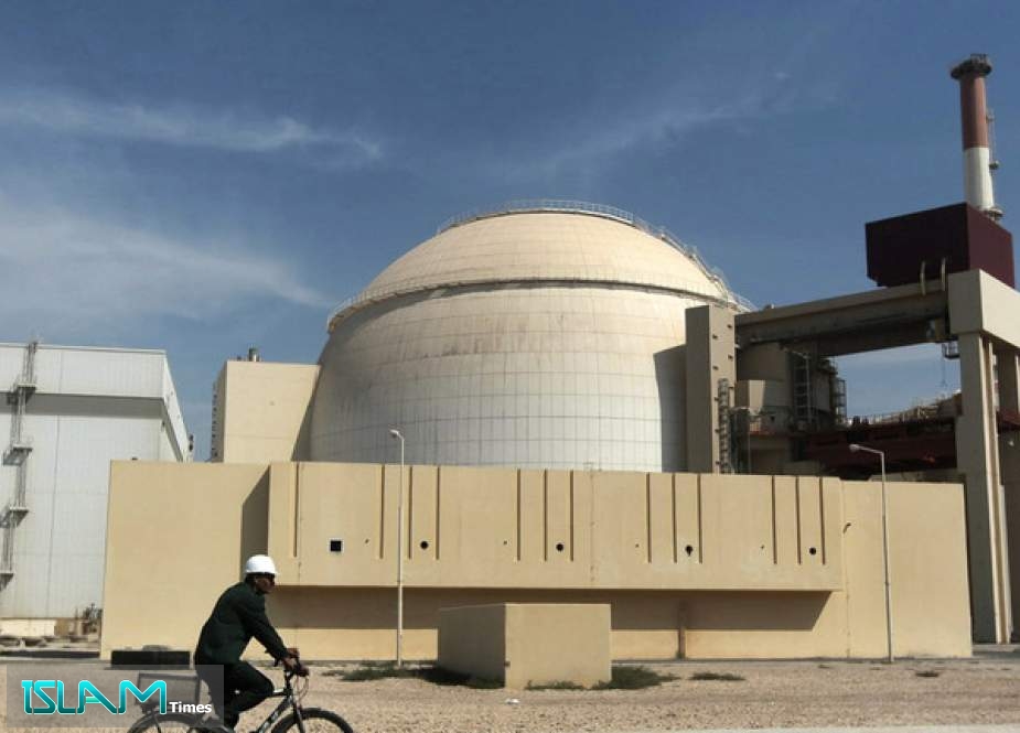 A worker rides a bicycle in front of the reactor building of the Bushehr nuclear power plant, outside Bushehr, Iran, October 26, 2010
