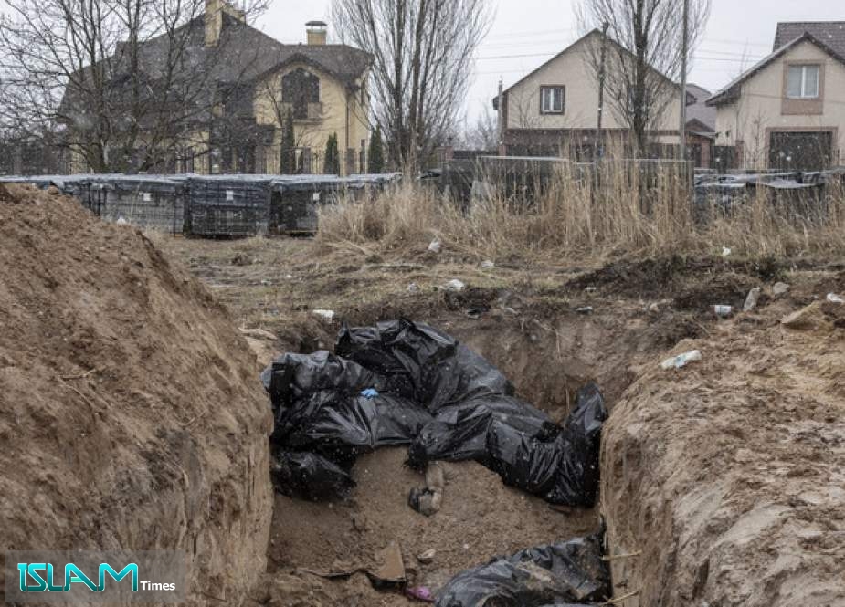 Bodies of civilians are seen in a mass grave in the town of Bucha, Ukraine on April 03, 2022.