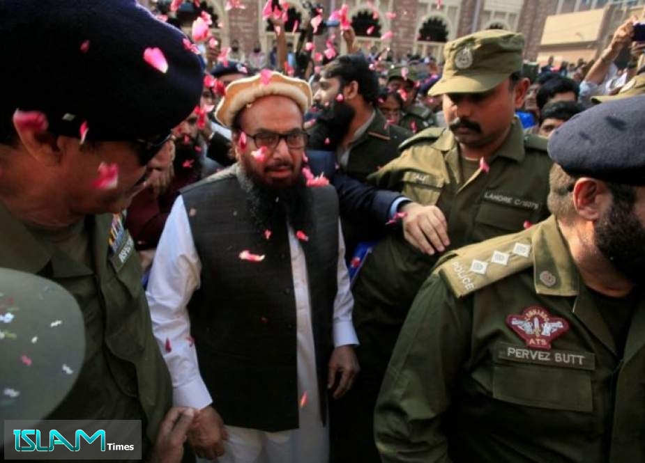 Hafiz Saeed walks to a Pakistani court before it ordered his release from house arrest in Lahore in this November 22, 2017.