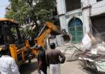 A bulldozer demolishes a part of a mosque in Jahangirpuri, New Delhi.