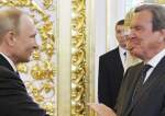Vladimir Putin shakes hands with Gerhard Schroeder during his inauguration ceremony as Russia