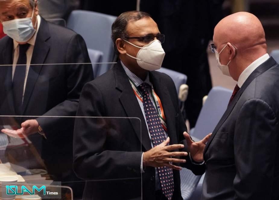 Ambassador of India to the UN, TS Tirumurti (C) speaks with Russian envoy to the UN Vasily Nebenzya during a UN security council meeting August 16, 2021.