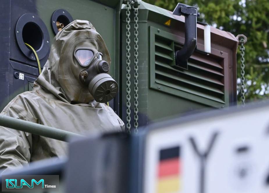 A soldier of the German Armed Forces wears NBC protective equipment.