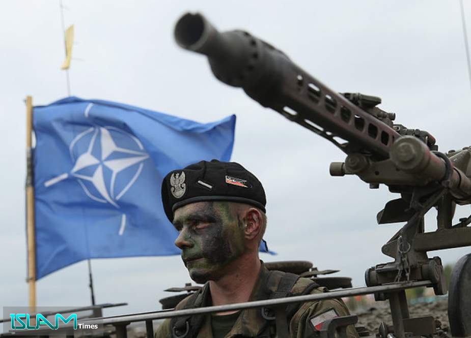 A NATO flag flies above a military exercise in Poland, June 18, 2015