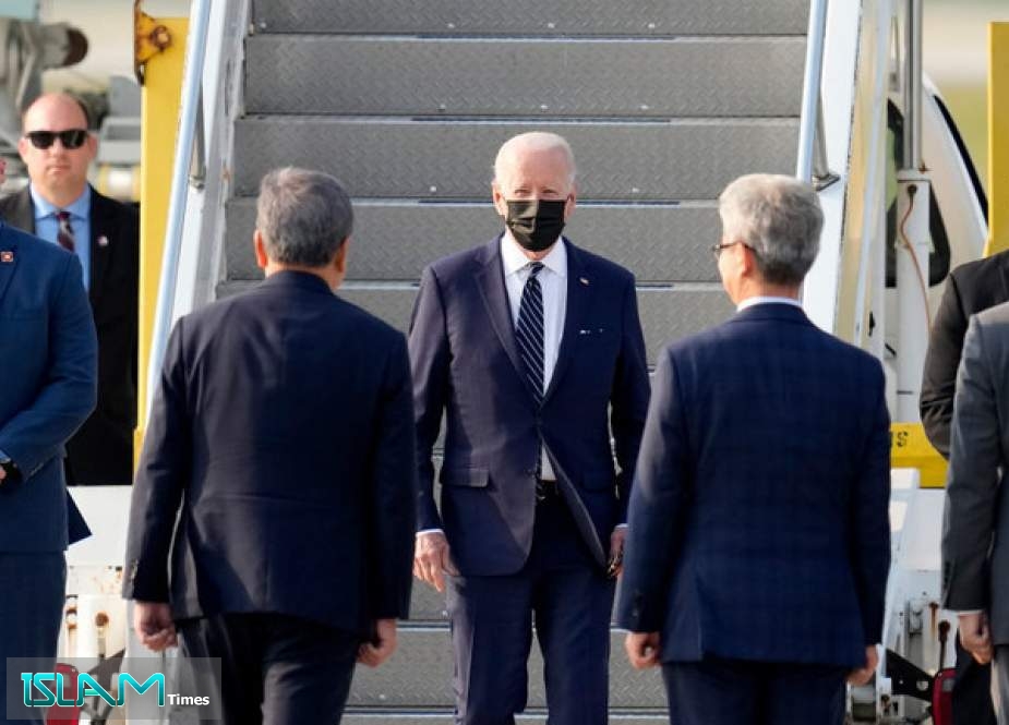 President Joe Biden, flanked by Secret Service agents, is shown arriving in South Korea on Friday.