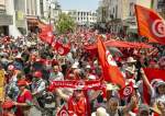Demonstrators carry flags as they gather during a protest against Tunisian President Kais Saied in Tunis, June 19, 2022.