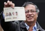Colombian left-wing presidential candidate Gustavo Petro of the Historic Pact coalition shows his ballot before casting his vote at a polling station in Bogota, Colombia June 19, 2022.