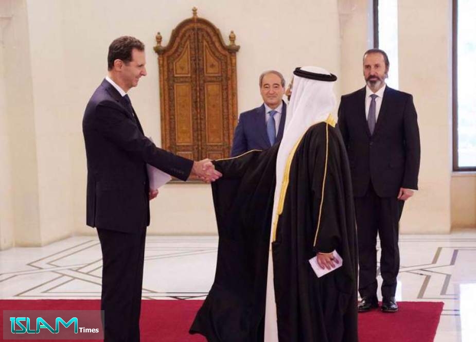 Syrian President Bashar al-Assad (L) shakes hands with Bahraini Ambassador Waheed Mubarak Sayyar at the Presidential Palace in the capital Damascus on June 19, 2022.