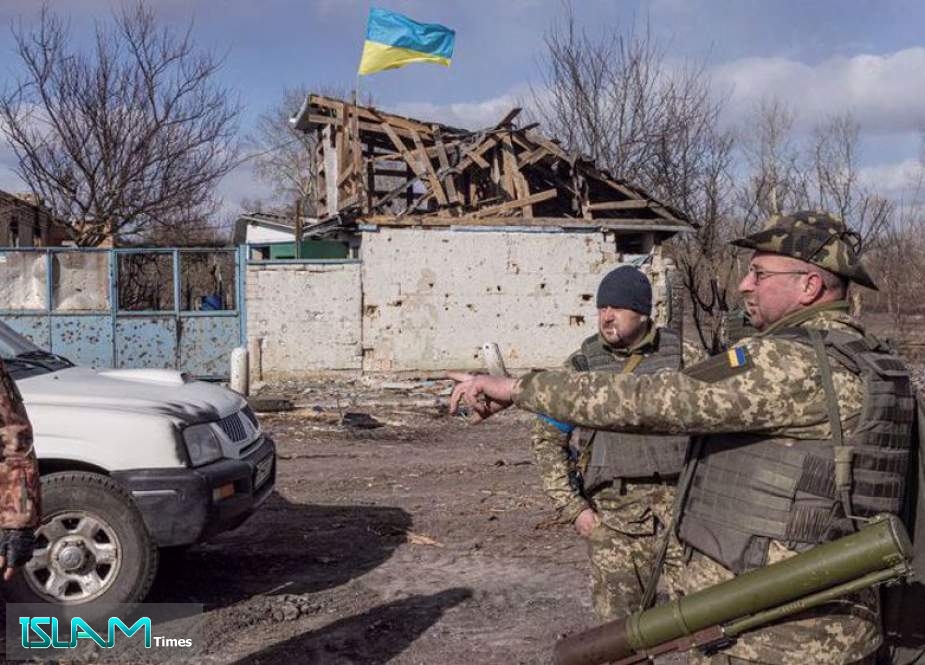Ukrainian servicemen stand in the village of Lukyanivka outside Kyiv, as Russia