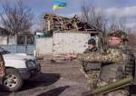 Ukrainian servicemen stand in the village of Lukyanivka outside Kyiv, as Russia