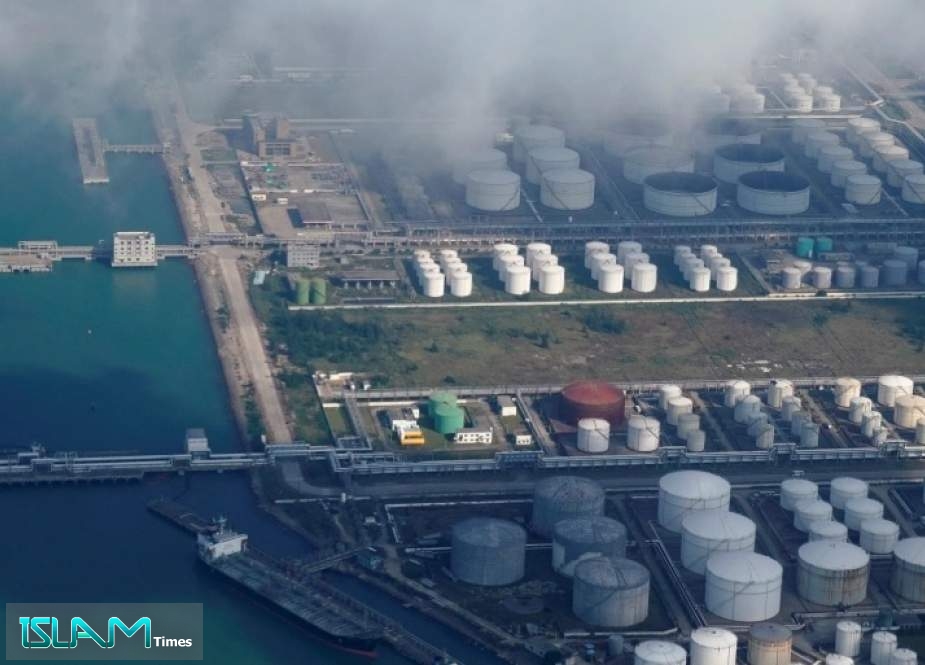 Oil and gas tanks are seen at an oil warehouse at a port in Zhuhai, China in 2018