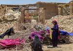 Afghan people keep their clothes to dry on dried-out shrubs near the ruins of houses damaged by an earthquake in Bermal district, Paktika province, on June 23, 2022.