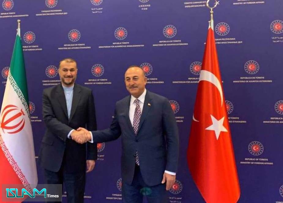 Iran’s Foreign Minister Hossein Amir-Abdollahian (L) shakes hands with his Turkish counterpart Mevlut Cavusoglu in Ankara on June 27, 2022.