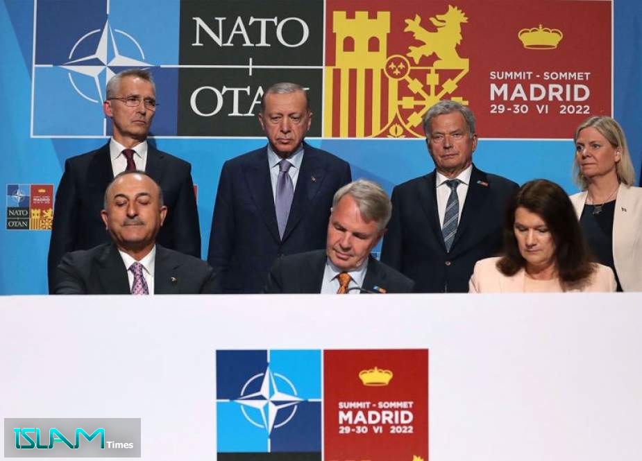 This handout photograph taken and released on June 28, 2022 in Madrid by the Turkish presidential press office, shows (Back, From L) NATO’s Secretary-General Jens Stoltenberg, Turkey