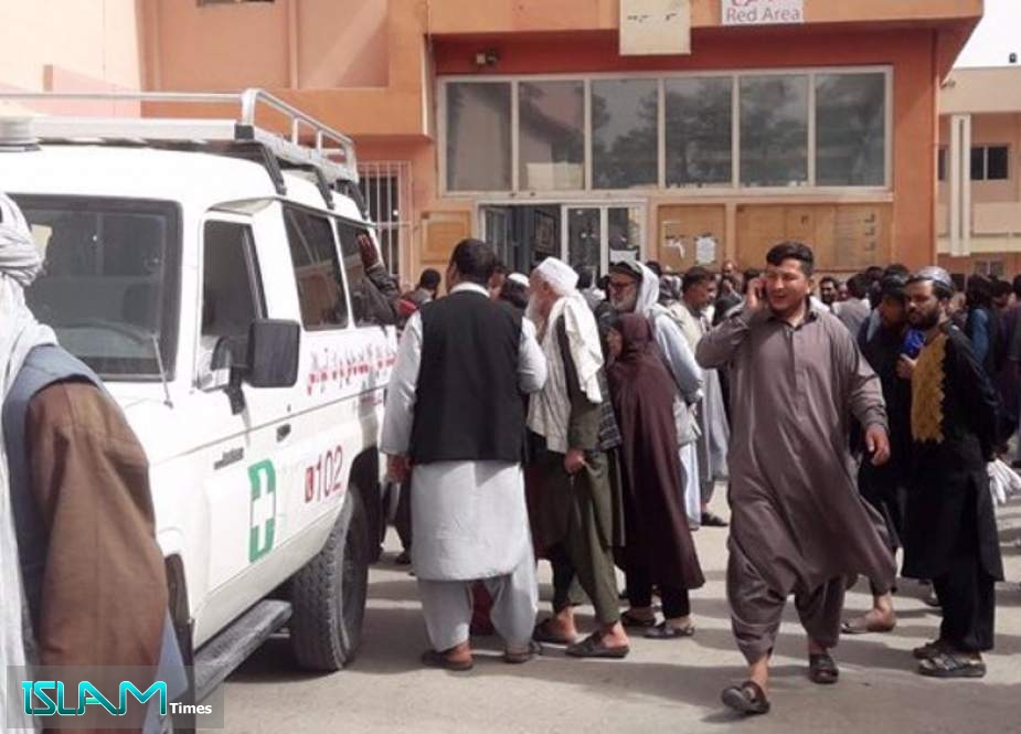 This photo shows Afghan people gathering besides an ambulance after an attack on a convoy carrying Taliban members in Herat in western Afghanistan on July 4, 2022.