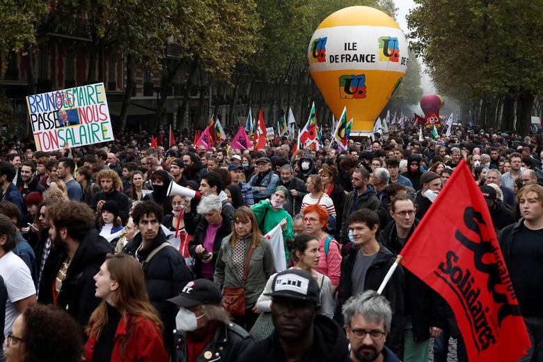 Protestors attend a demonstration in Paris as part of a nationwide day of strike and protests in France, October 18. The sogan reads 