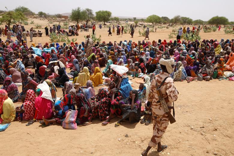 Sudanese refugees, who have fled the violence in their country, wait to receive food rations from World Food Programme (WFP), near the border between Sudan and Chad, in Koufroun, Chad, May 9.