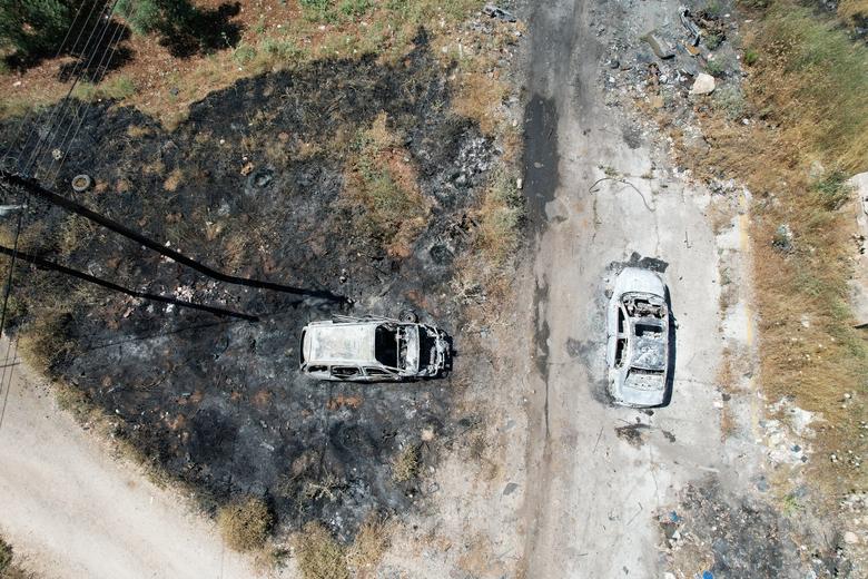 An aerial view shows burned vehicles after an attack by Israeli settlers near Ramallah in the Israeli-occupied West Bank, June 21, 2023. Israeli settlers attacked Palestinian towns in the occupied West Bank overnight, torching buildings and cars in appar