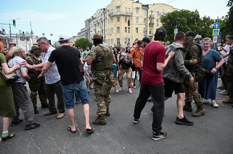 Supporters and opponents of Wagner private mercenary group have an argument near the headquarters of the Southern Military District controlled by Wagner fighters in the city of Rostov-on-Don, Russia, June 24.