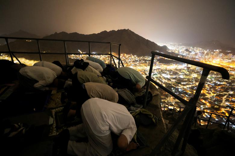 Muslim pilgrims pray during a visit to Mount Al-Noor, where Muslims believe Prophet Mohammad received the first words of the Koran through Gabriel in the Hira cave, in the holy city of Mecca, Saudi Arabia, June 24.