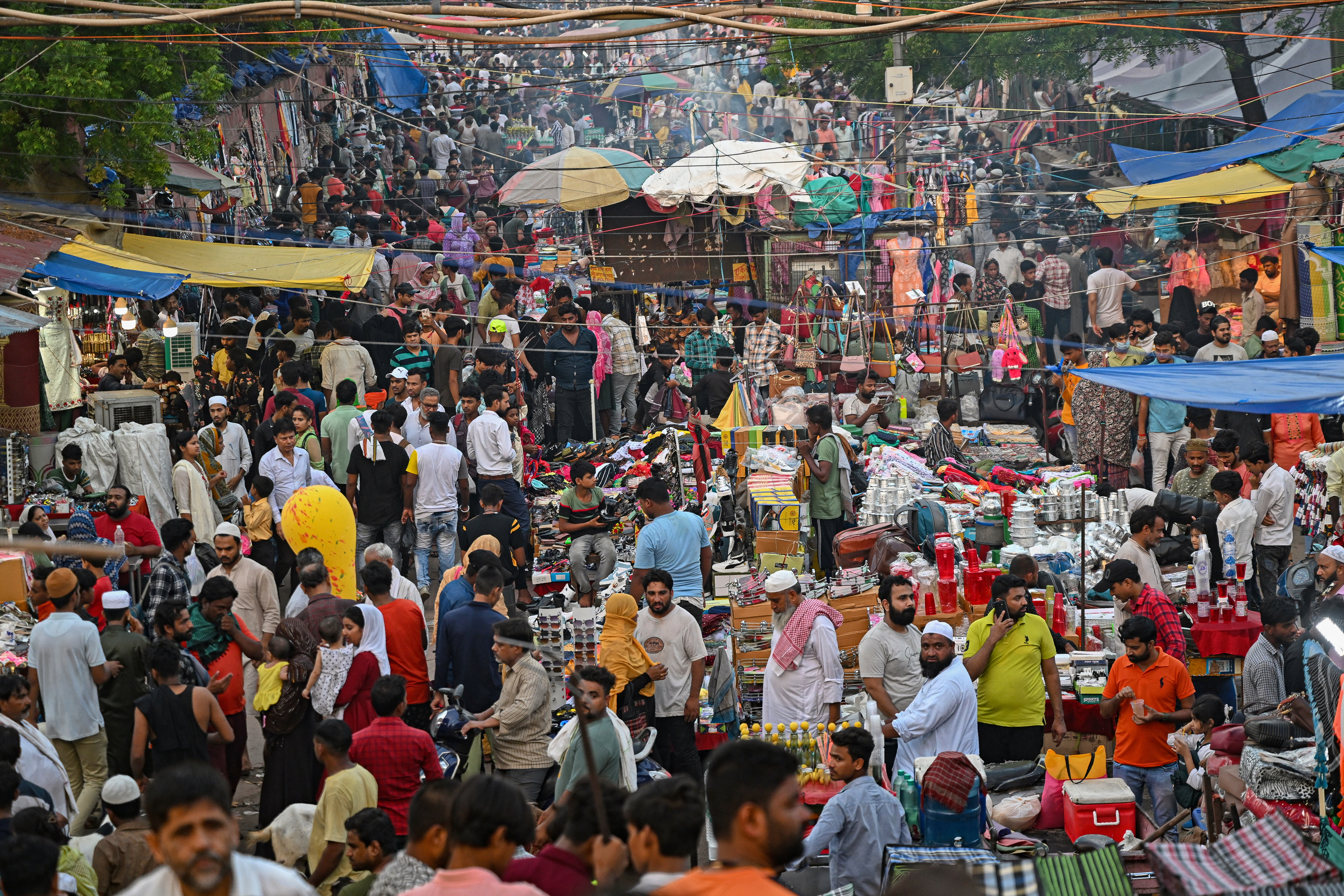 People crowd into a market ahead of Eid al-Adha in the old quarters of New Delhi.